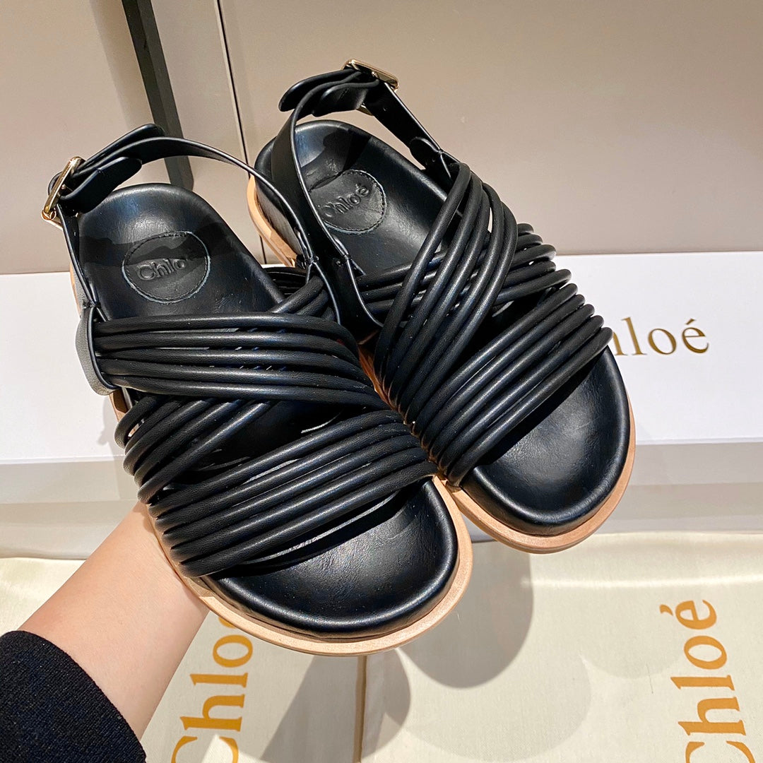 CROSS STRAP SANDAL IN BLACK RUBBER WITH GOLD HARDWARE