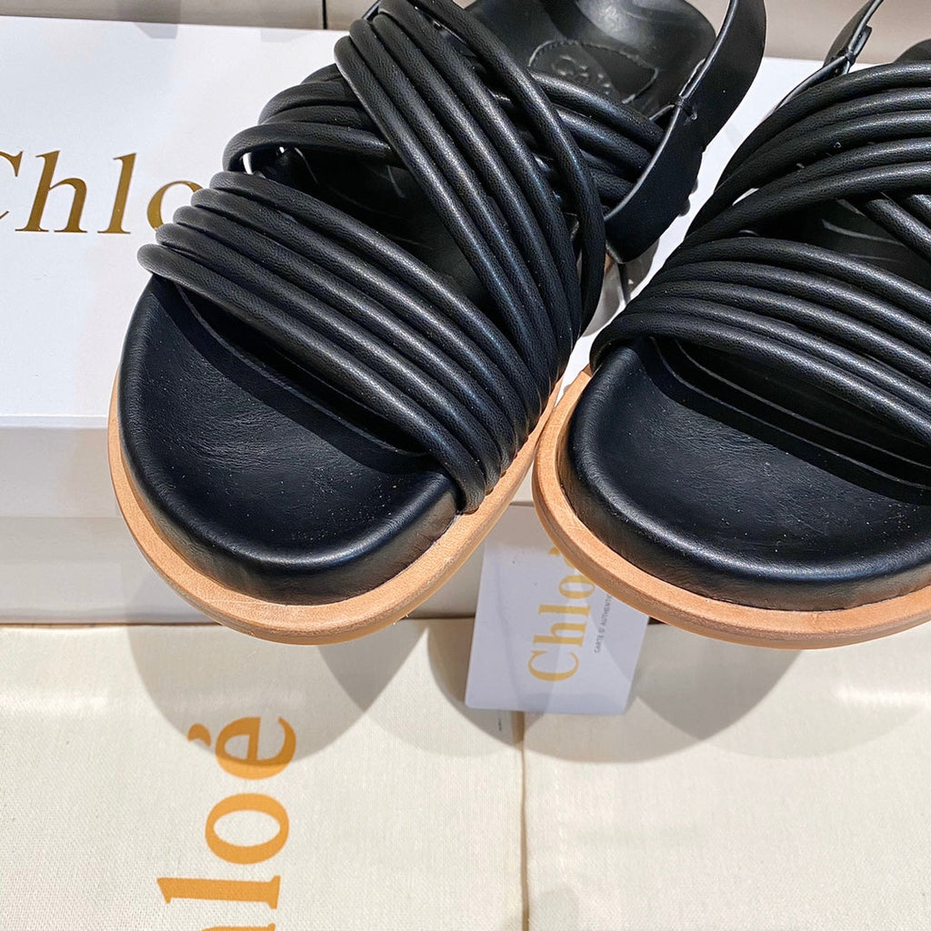 CROSS STRAP SANDAL IN BLACK RUBBER WITH GOLD HARDWARE
